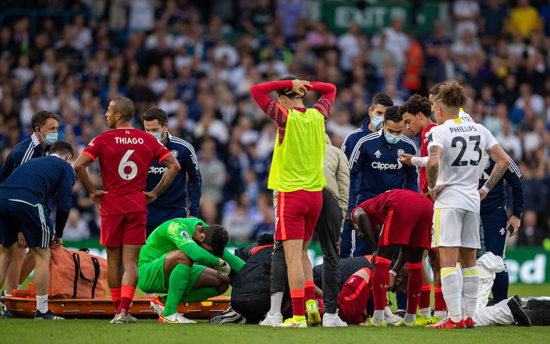 Liverpool's players look on as Harvey Elliott receives treatment for an injury before being carried off during the FA Premier League match between Leeds United FC and Liverpool FC at Elland Road