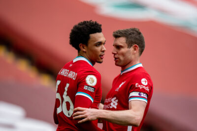 Trent Alexander-Arnold (L) celebrates with team-mate James Milner after scoring the winning second goal during the FA Premier League match between Liverpool FC and Aston Villa FC at Anfield