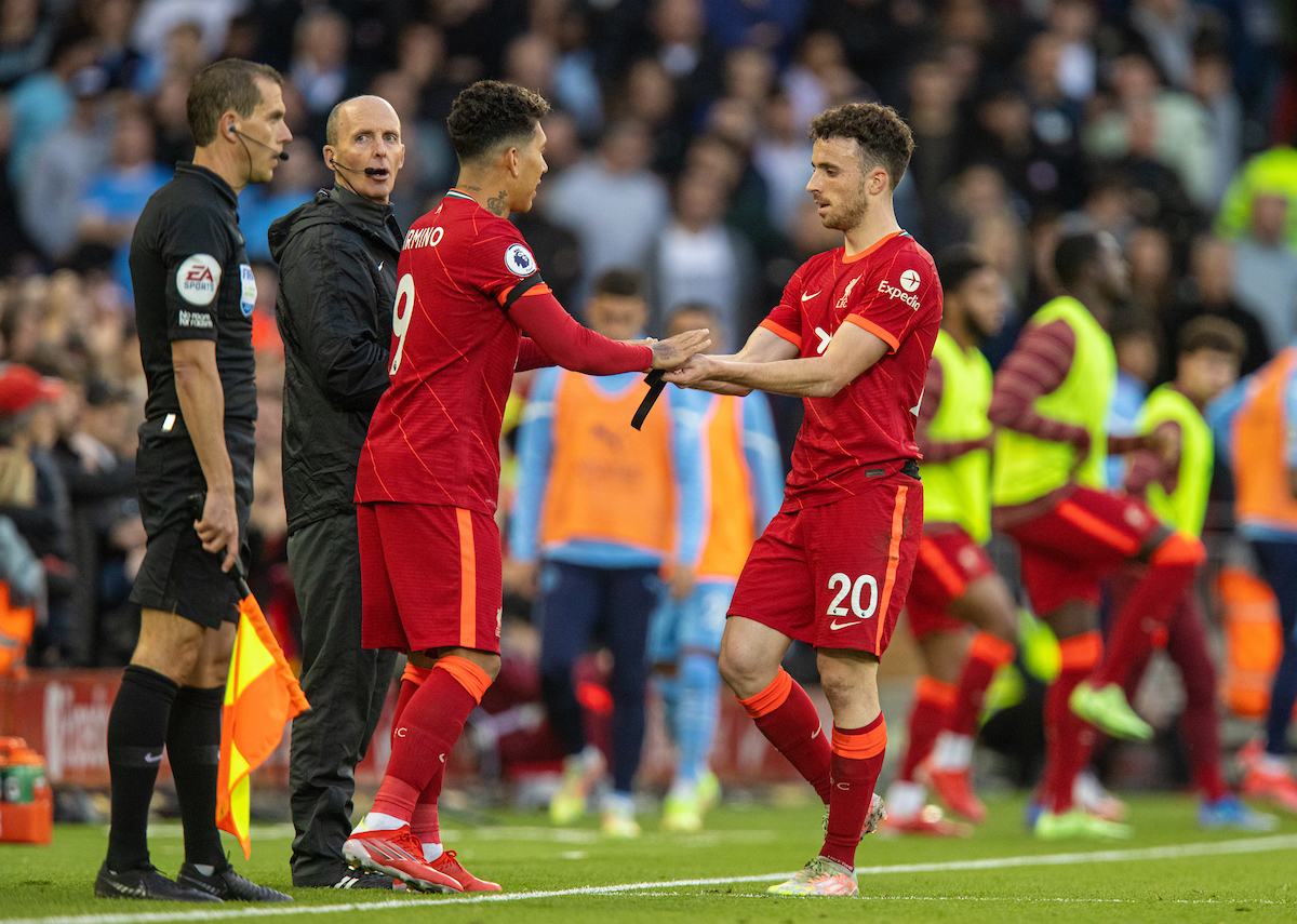 Liverpool's substitute Roberto Firmino (L) replaces Diogo Jota during the FA Premier League match between Liverpool FC and Manchester City FC at Anfield