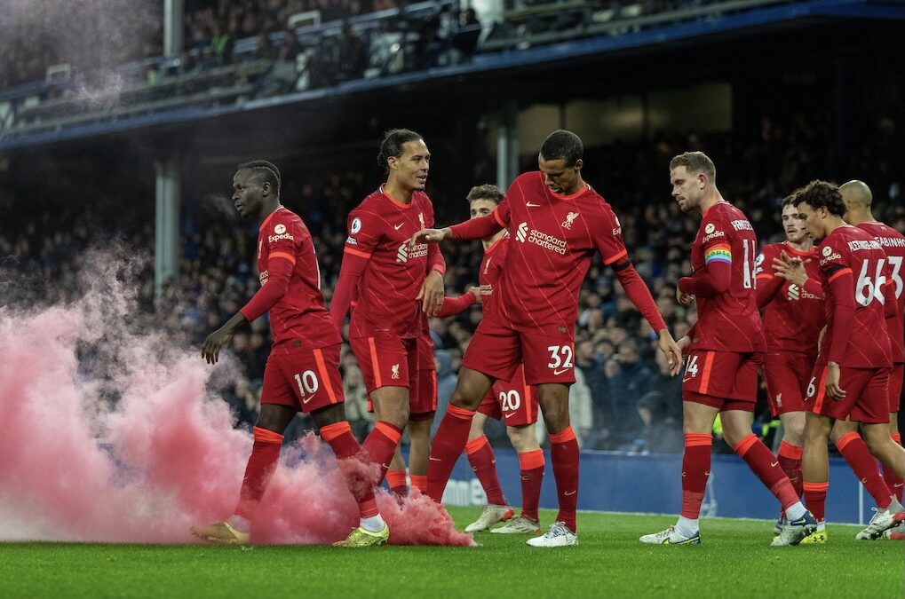 Liverpool's players look at a smoke bomb on the pitch as Mohamed Salah celebrates after scoring the third goal during the FA Premier League match between Everton FC and Liverpool FC, the 239th Merseyside Derby, at Goodison Park