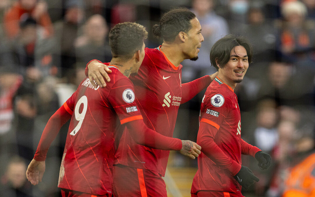 Liverpool's Takumi Minamino (R) celebrates after scoring the third goal during the FA Premier League match between Liverpool FC and Brentford FC at Anfield