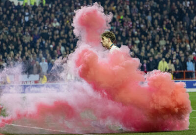 Liverpool's Kostas Tsimikas with a smoke bomb during the FA Cup Quarter-Final match between Nottingham Forest FC and Liverpool FC at the City Ground.