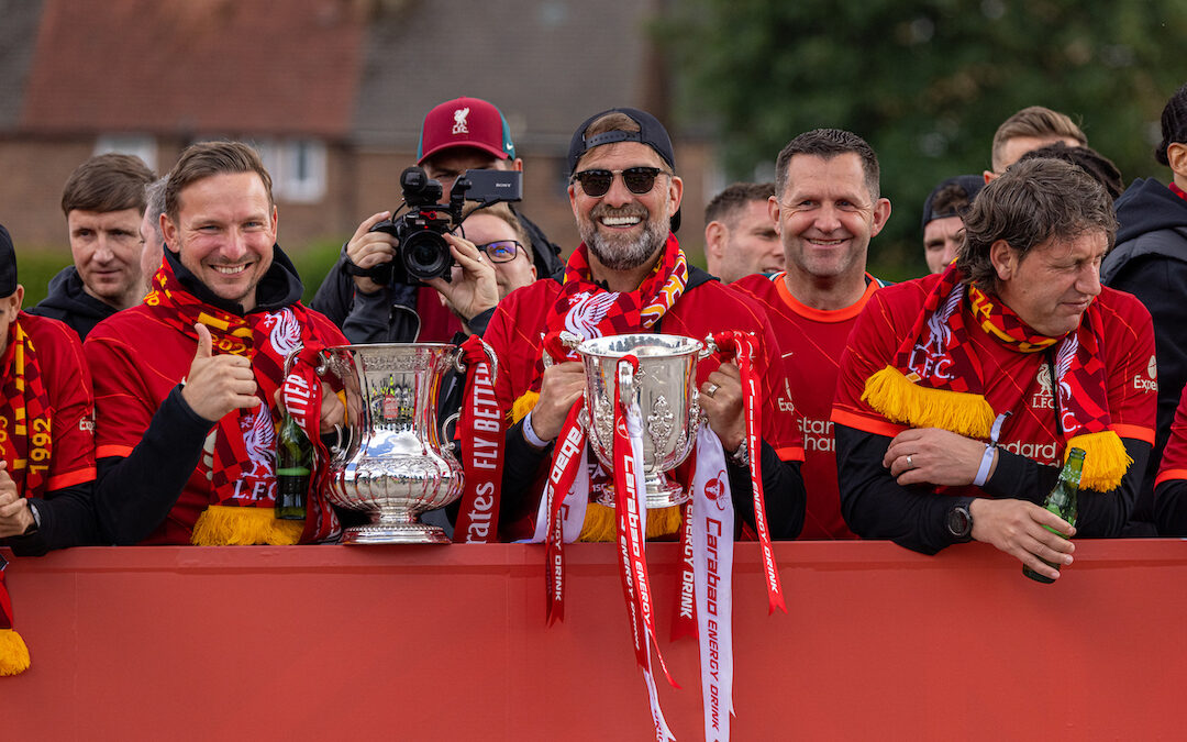 Liverpool's manager Jürgen Klopp (R) with first-team development coach Pepijn Lijnders (L) hold the two trophies during a parade around the city after the club won the Cup Double, the FA Cup abd Football League Cup