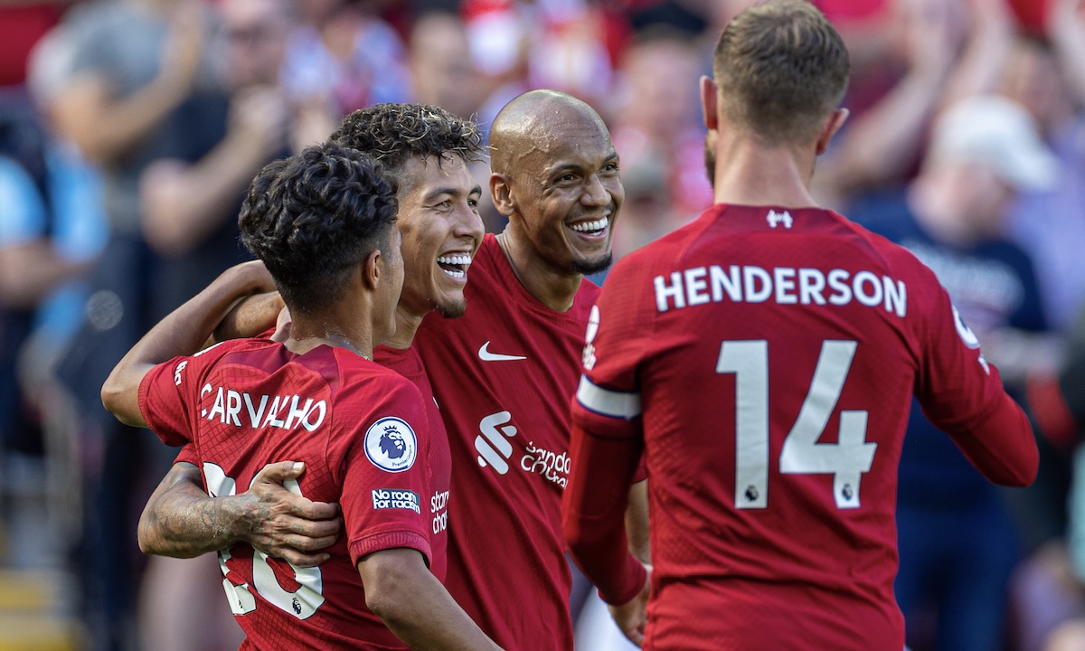 Liverpool's Roberto Firmino (C) celebrates with team-mates Fábio Carvalho (L) and Fabio Henrique Tavares 'Fabinho' (R) after scoring the seventh goal during the FA Premier League match between Liverpool FC and AFC Bournemouth at Anfield