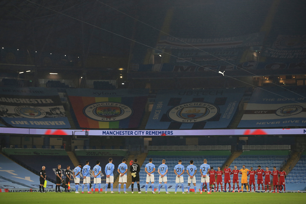 Liverpool and Manchester City players stand for a minute's silence for Remembrance Sunday before the FA Premier League match between Manchester City FC and Liverpool FC at the City of Manchester Stadium