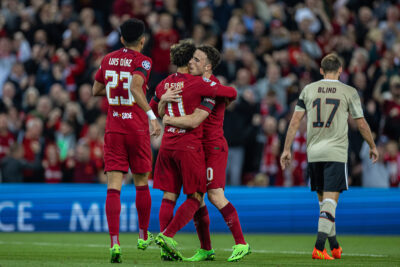 Liverpool's Mohamed Salah (C) celebrates with team-mate Diogo Jota (R) after scoring the first goal during the UEFA Champions League Group A matchday 2 game between Liverpool FC and AFC Ajax at Anfield