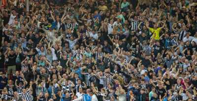 Newcastle United supporters celebrate during the FA Premier League match between Liverpool FC and Newcastle United FC at Anfield