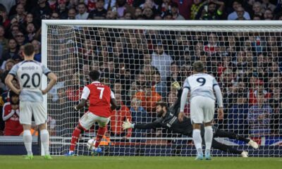 Arsenal's Bukayo Saka scores the third goal past Liverpool's goalkeeper Alisson Becker from a penalty kick during the FA Premier League match between Arsenal FC and Liverpool FC at the Emirates Stadium