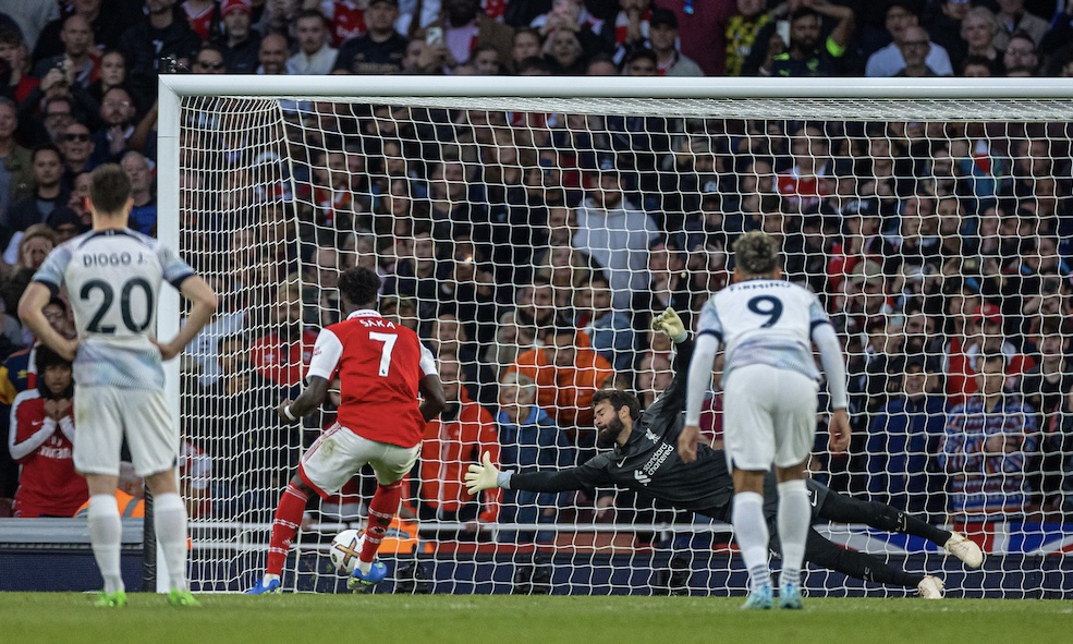 Arsenal's Bukayo Saka scores the third goal past Liverpool's goalkeeper Alisson Becker from a penalty kick during the FA Premier League match between Arsenal FC and Liverpool FC at the Emirates Stadium