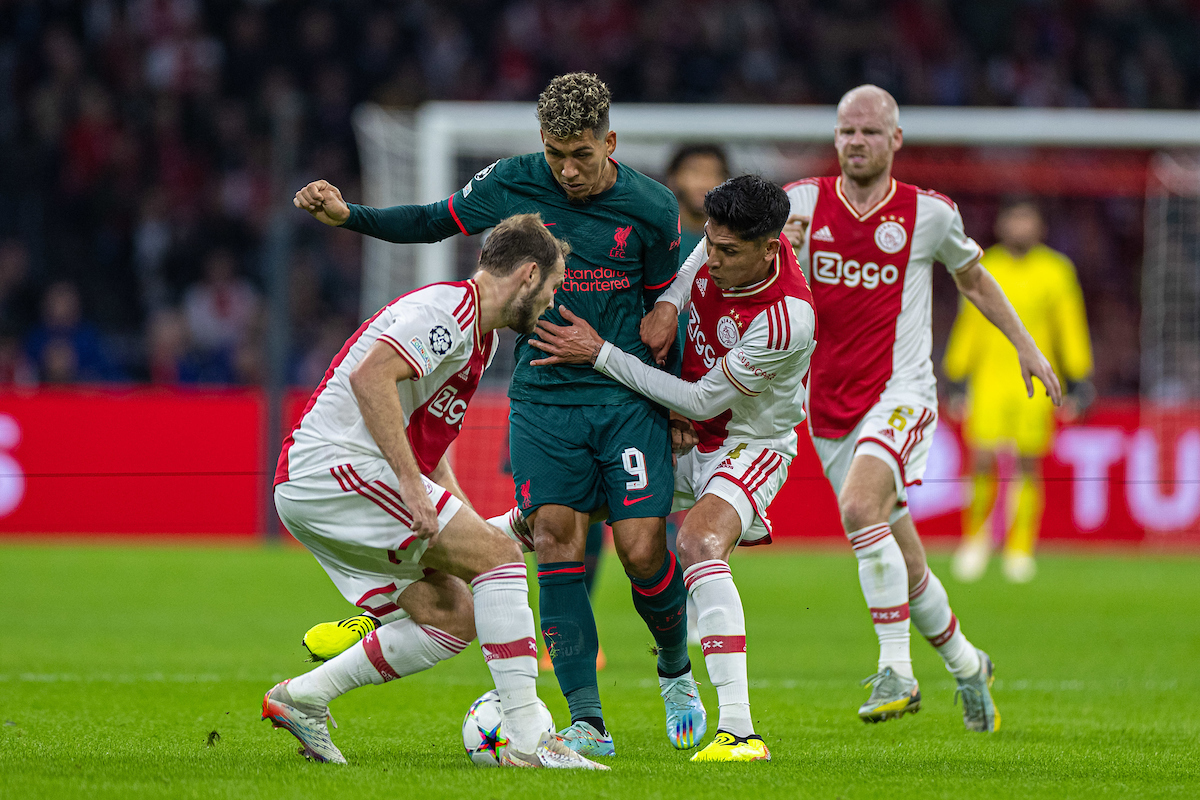 Liverpool's Roberto Firmino (C) is challenged by AFC Ajax's Daley Blind (L) and Edson Álvarez during the UEFA Champions League Group A matchday 5 game between AFC Ajax and Liverpool FC at the Amsterdam Arena