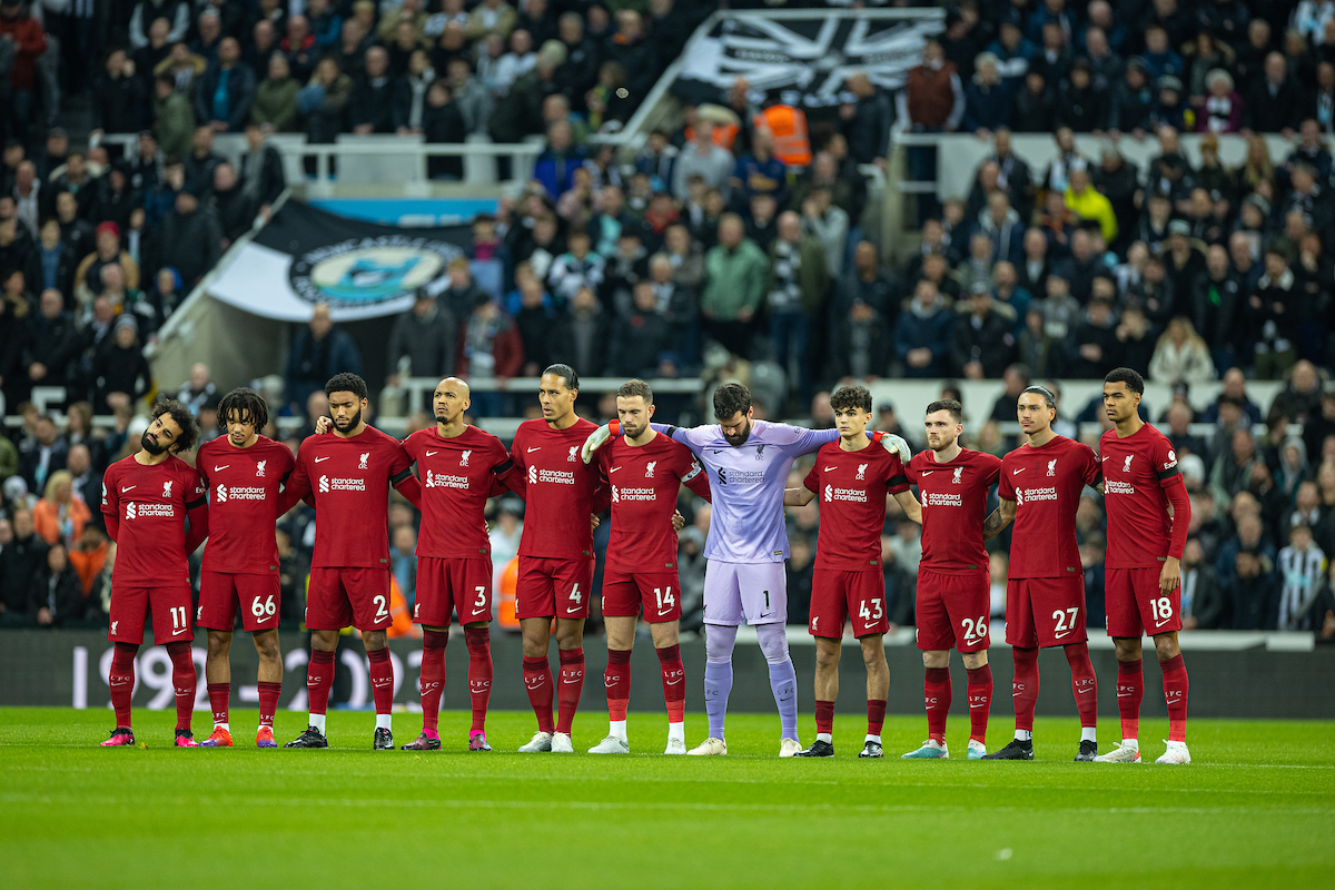 Liverpool players stand for a moment to remember Christian Atsu, who died in the Syria and Turkey earthquake, during the FA Premier League match between Newcastle United FC and Liverpool FC at St. James' Park