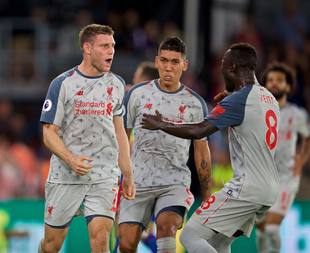 Liverpool's James Milner celebrates scoring the first goal from a penalty kick with team-mate Roberto Firmino (centre) and Naby Keita (right) during the FA Premier League match between Crystal Palace and Liverpool FC at Selhurst Park
